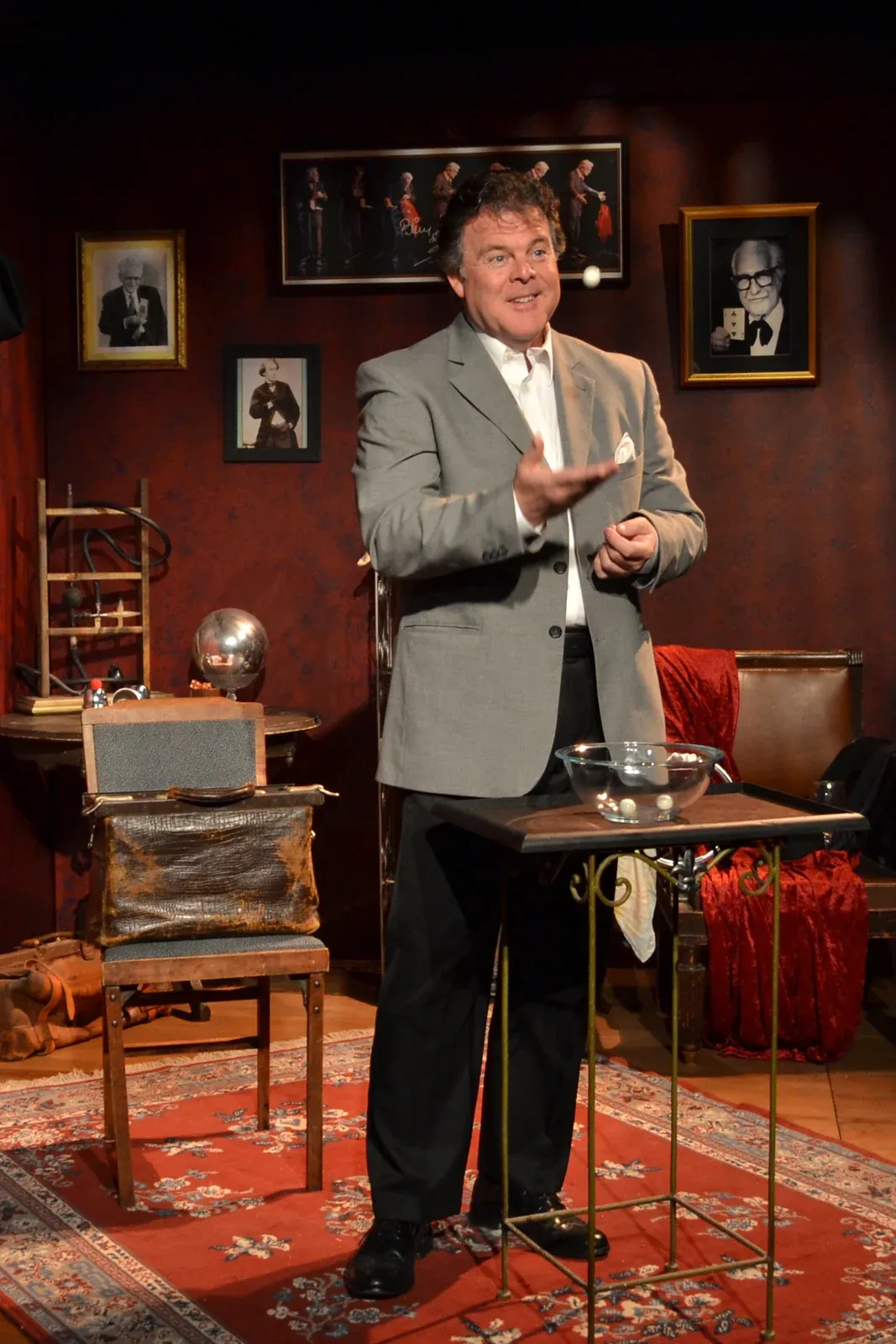 John tossing a small white ball above his hand
